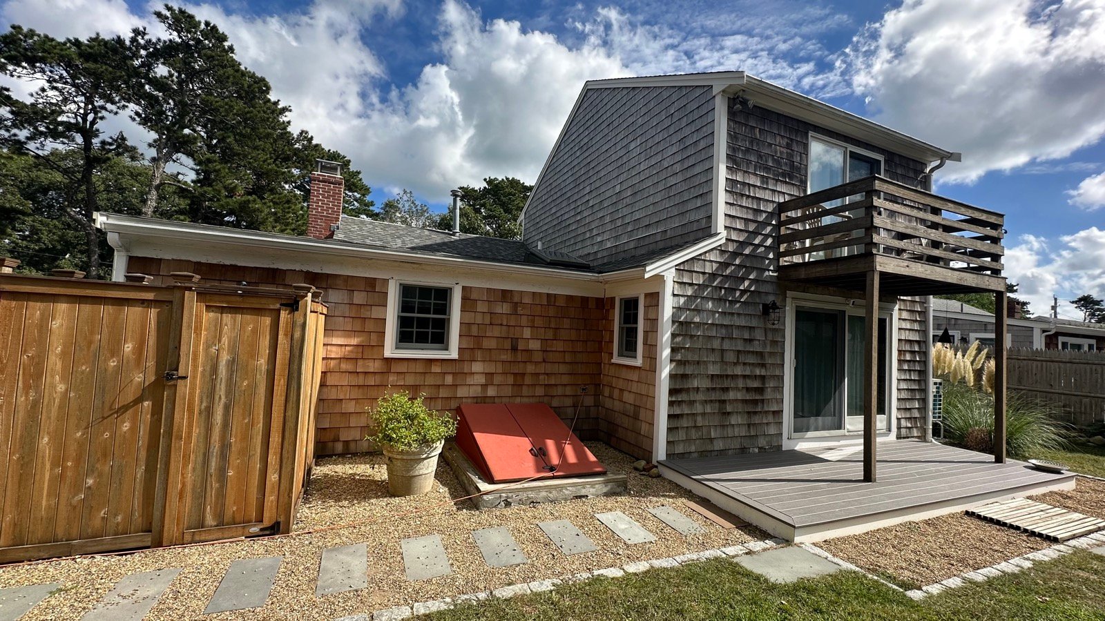 New cedar shake siding installed on a Cape home in Dennis, MA by West Mountain Construction