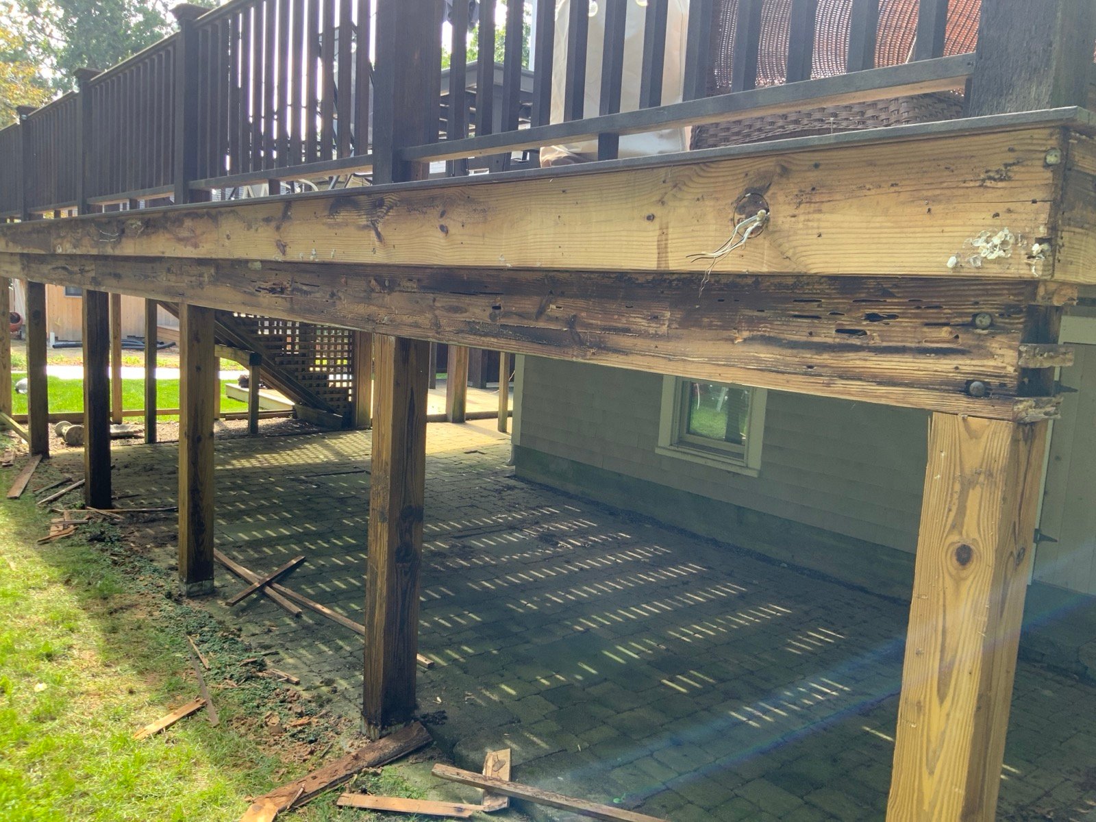 Rotted carrying beam found under an elevated deck in Dennis, MA before rebuild by West Mountain Construction