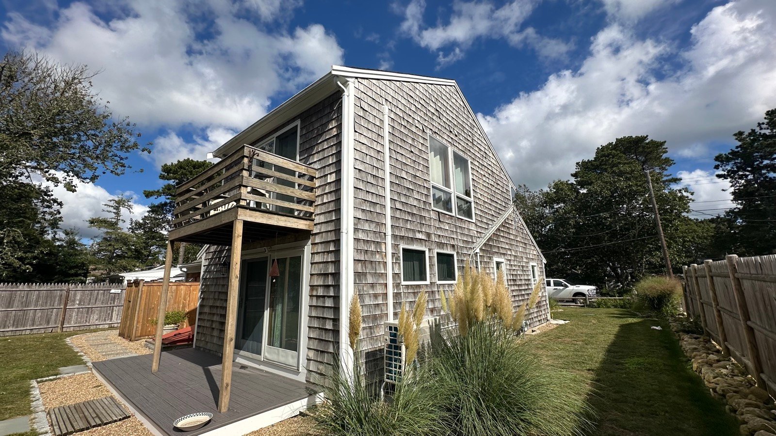 Aged cedar shingle elevation on a Dennis, MA home before siding replacement